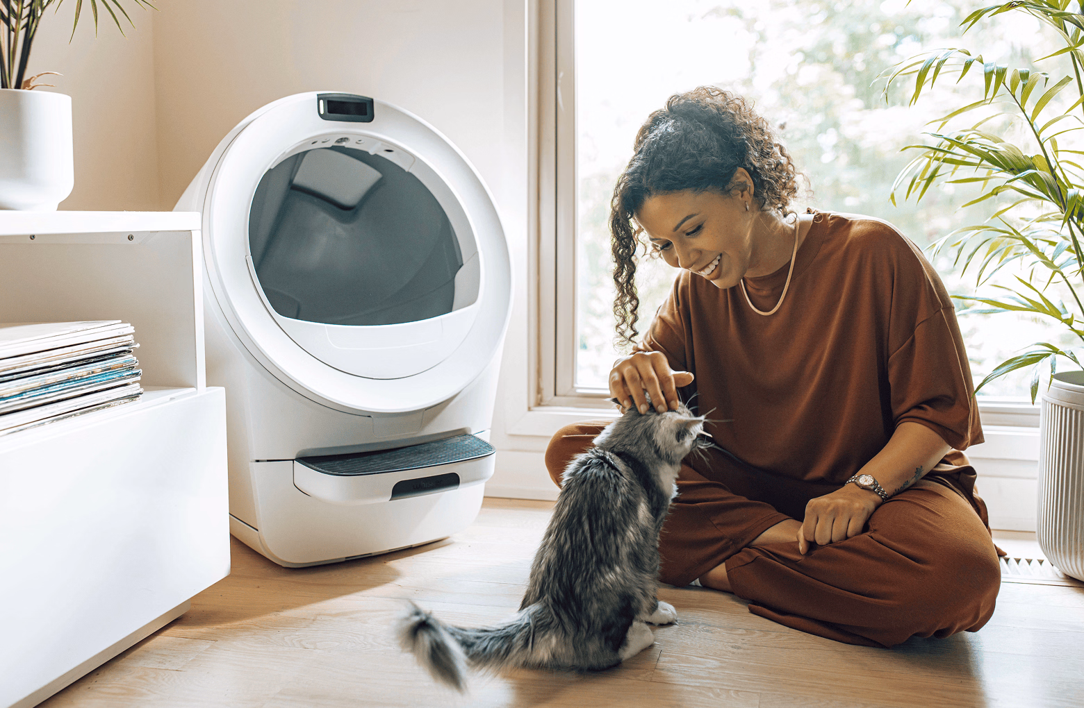 Litter-Robot EVO model with cat and pet owner
