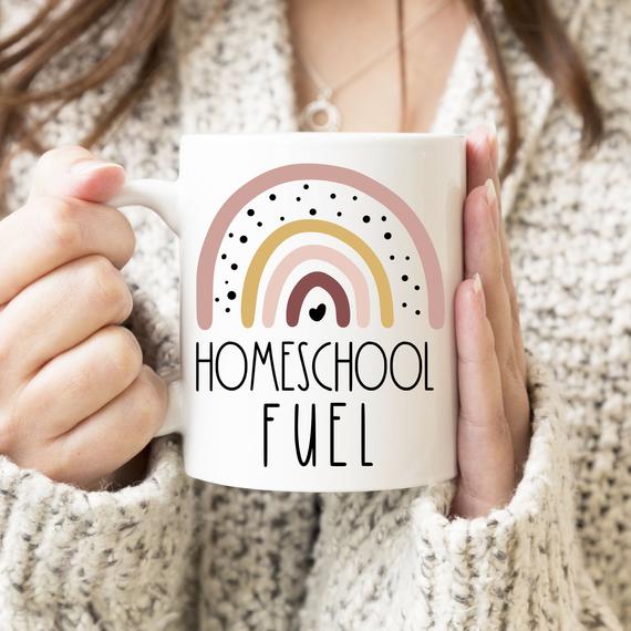 Mom holding Homeschool Fuel coffee mug